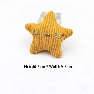 Detail view of yellow corduroy star accessory with closed eye embroidery, size 5cm x 5.5cm