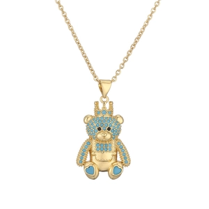 Golden necklace featuring a crown teddy bear pendant with blue gemstones and blue heart charm