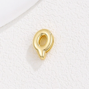 Detailed view of a shiny gold-plated metal letter O charm for 10mm DIY bracelets