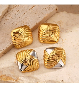 Macro shot of geometric square stud earrings with spiral texture in gold and two-tone finish