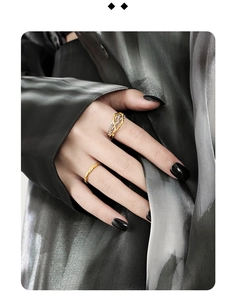 Detail of S925 silver rings showing bicolor intertwined design and hammered texture finish