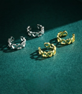 Detailed view of S925 sterling silver heart-shaped ear cuffs in gold and silver finish
