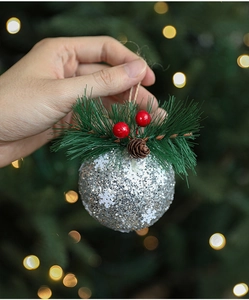 Silver Christmas ornament with glitter snowflakes, pine needles, berries and pine cones