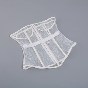 Detailed top view of white lace corset with boning structure on a flat grey surface