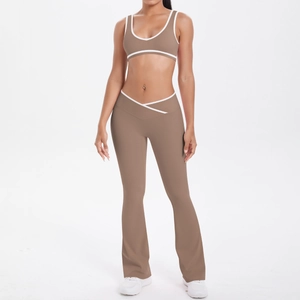 Detail of high-waisted yoga pants with V-shaped waistband and white contrast piping