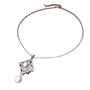 Elegant silver necklace with zircon hollow pendant and pearls on a white background