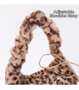 Close-up of leopard print plush bag featuring the soft handle and adjustable strap detail