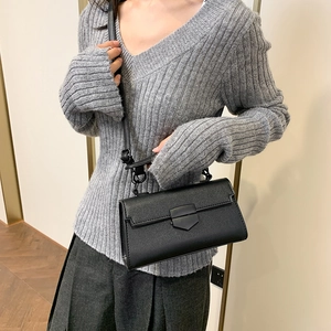 Retro black stone texture crossbody handbag worn by model for a minimalist look