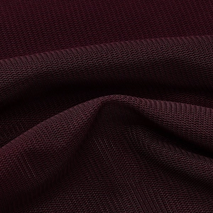 Close-up of elegant burgundy mesh fabric with soft folds and breathable knit texture