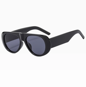 Detail view of bold black resin frames and dark grey UV protection lenses on sunglasses