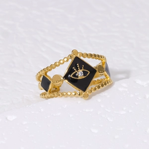 Detail of 18K gold plated stainless steel ring featuring evil eye enamel and zircon
