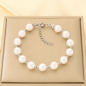 Detailed shot of pearl bracelet featuring a silver lobster clasp and extension chain