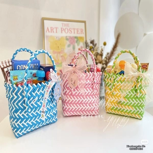 Three colorful woven mini gift baskets with snack fillers and happy birthday ribbons