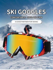 Detail of red and black graffiti ski goggles with orange lenses against a snowy mountain background