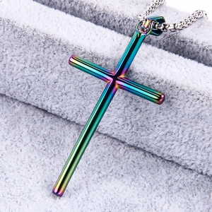 Rainbow gradient stainless steel cross pendant necklace with metallic luster on fabric