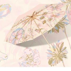 Detailed view of pink floral sun umbrella with butterfly pattern and wooden handle