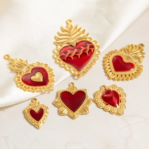 Gothic 18K gold plated stainless steel heart pendants on white silk background