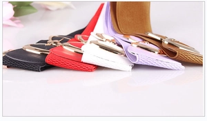 Detailed view of elastic waist belts in five colors with gold bow-knot metal buckles