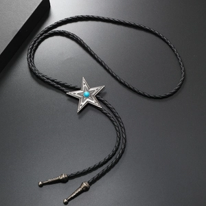 Close-up of vintage star bolo tie slider with turquoise stone and braided leather cord
