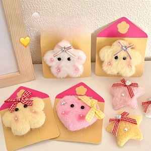 Detailed close-up of plush star and heart hair clips with cute bows and pearl accents
