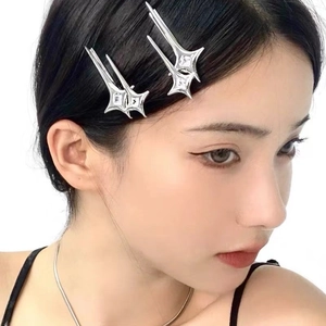 Y2K silver star metal hair clips with rhinestone accents worn by female model