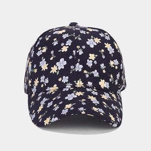 Detailed view of dark blue floral baseball cap with purple and yellow flower patterns