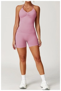 Detail of seamless high waist yoga shorts and halter top with chest pleats in dusty pink