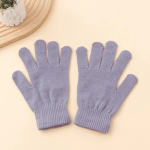 Detailed close-up of light purple knitted gloves with elastic ribbed cuffs on a warm background