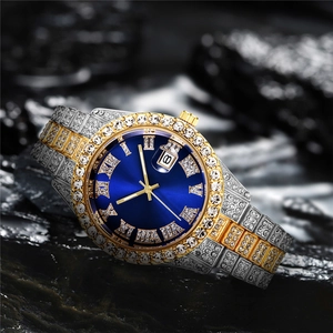 Close-up of luxury iced-out watch with blue sunray dial and diamond-encrusted steel band