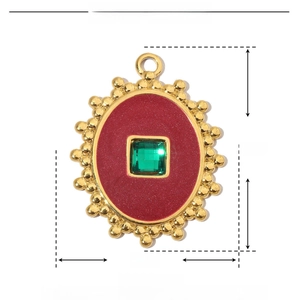 Detail showing dimensions 29x22mm of vintage oval pendant with green stone and red enamel