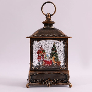Macro view of vintage bronze water globe lantern with Santa Claus and glitter snow