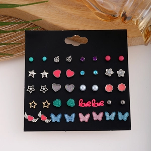 Set 20 paia orecchini a lobo con fiori, farfalle, cuori e stelle su supporto nero