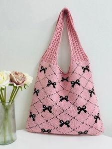 Pink knitted tote bag with black bow patterns and diamond texture for women