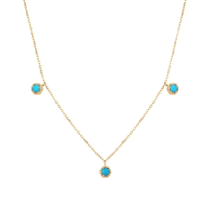 Macro detail of S925 silver necklace featuring three round turquoise pendants on a gold chain