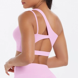 Detailed back view of pink yoga sports bra featuring asymmetric multi-strap hollow design