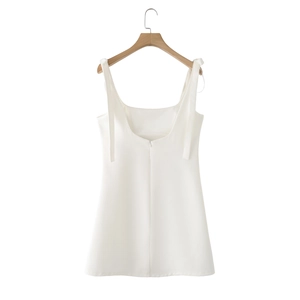 Detail of white strap dress featuring a U-neckline and back invisible zipper closure