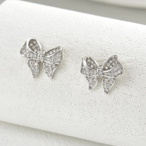 Elegant silver bow knot stud earrings with shimmering cubic zirconia inlay for women