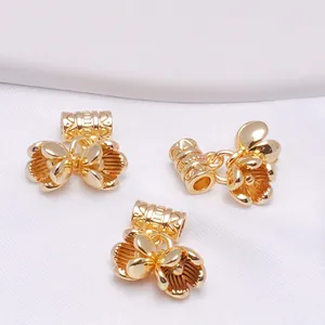 Macro shot of three 14K gold-plated lily of the valley floral beads for DIY jewelry making