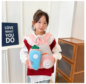 Toddler girl pink backpack with 3D bunny and carrot details worn by a child model