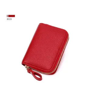 Detail view of red pebbled leather RFID card holder with golden zipper and puller