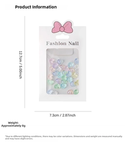 Detail view of colorful resin heart nail art charms in a fashion packaging box
