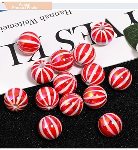 Detail of red and white striped UV plated pumpkin beads for DIY jewelry and phone charms