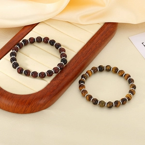 Brown and red tiger eye stone beaded bracelets with metal spacers on jewelry tray
