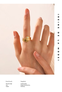 Macro view of irregular liquid wave texture on 18K gold plated stainless steel ring