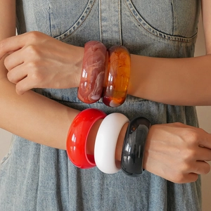 Minimalist geometric resin bangle set in red, white, black, and amber marble finishes