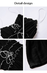 Detailed views of black pleated camisole with white ruffles and lace-up front design