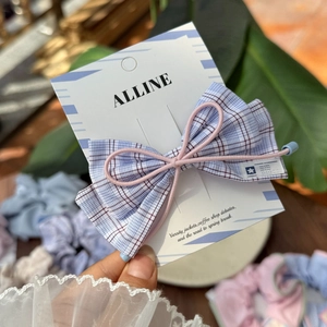 Sweet plaid bow hair accessory with pink elastic band and blue-white-red check pattern