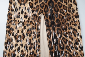 Detailed view of the leopard print dress featuring sequins and a side slit design