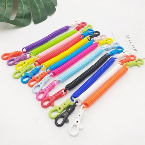 Close-up of colorful plastic spring lanyards with dual lobster clasps in various bright hues