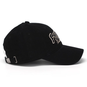 Detail of adjustable silver metal buckle and strap on back of black cotton baseball cap